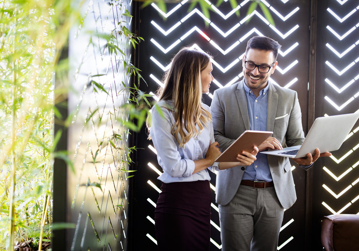 Happy business colleagues at meeting in modern office interior